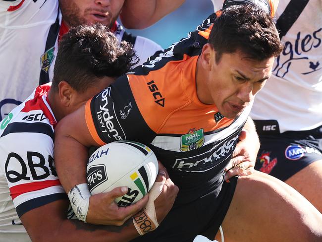 Tiger's Elijah Taylor tackled by Roosters' Jared Waerea-Hargreaves and Ryan Matterson during NRL match between the Wests Tigers and the Sydney Roosters at ANZ Stadium. Picture. Phil Hillyard