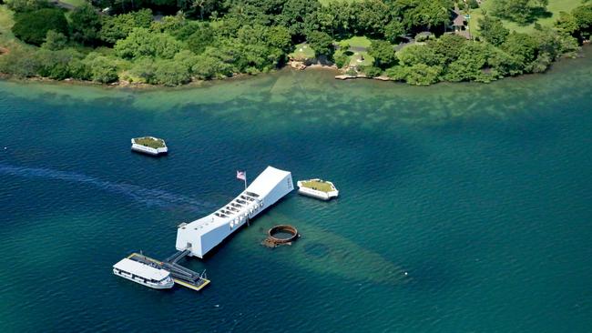 The USS Arizona and its memorial at Pearl Harbor. The memorial, visited by over 2 million people every year, is only accessible by boat, and the warship itself exits as a tomb for the men and women that perished there on December 7th, 1941. Picture: Nicholas Eagar