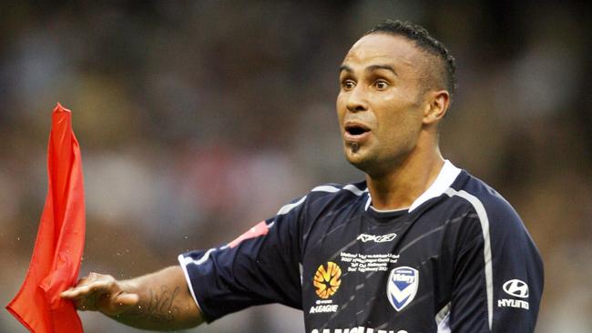 Melbourne's Archie Thompson celebrates his hat-trick goal in the 2007 Grand Final by chopping down the flag.