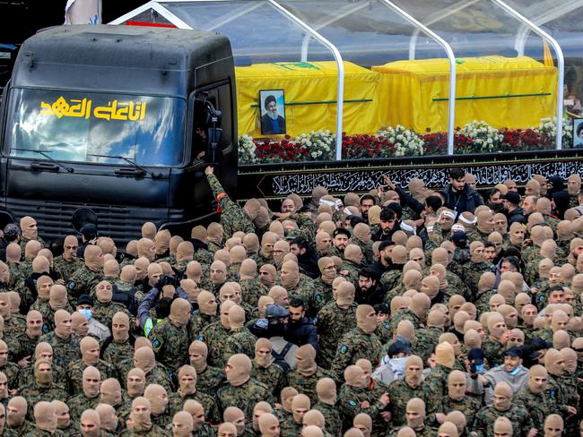 Mourners walk during the funeral procession with the vehicle carrying the coffins of Hezbollah’s slain leaders Hassan Nasrallah and Hashem Safieddine in Beirut. Picture: AFP