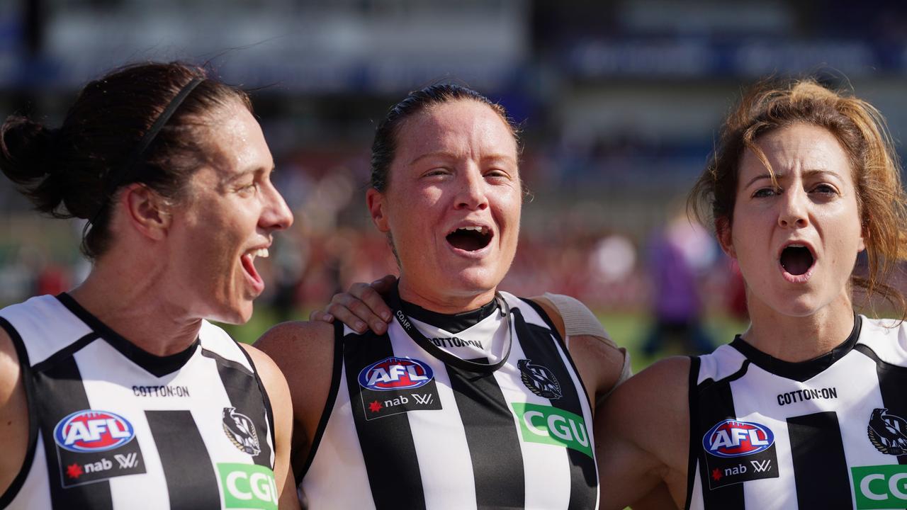 Stacey Livingstone of the Magpies (centre) celebrates a win with Ash Brazill (left) and Steph Chiocci.