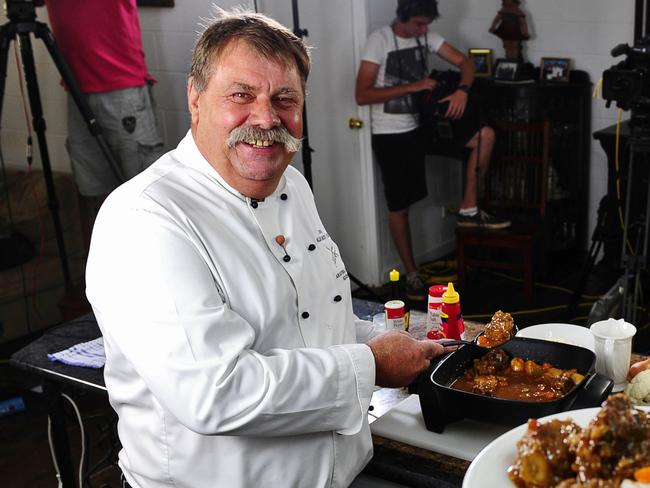 Walkabout Chef, Steve Sunk, with assistant Richard Garling, film cooking demonstrations for the menu cards he has created for people in remote communities.