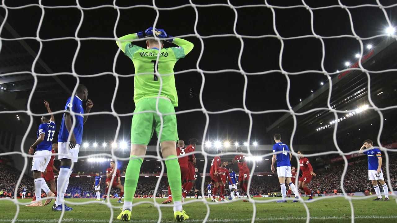 Everton goalkeeper Jordan Pickford reacts after Liverpool forward Divock Origi scored his side's first goal