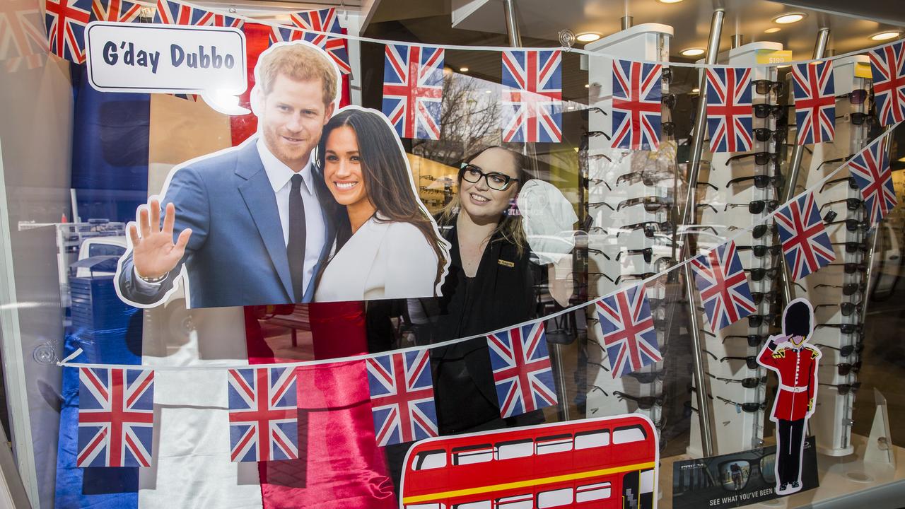 Angela Higgins cleans the window at Burgan and Brennan Optometry where they have a display to welcome the royal couple on their visit to Dubbo. Picture: Dylan Robinson