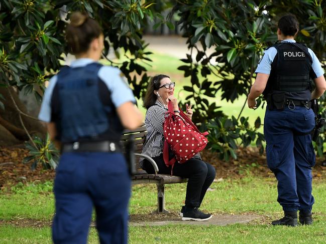 A lone woman is also approached by police at Rushcutters Bay. Picture: AAP