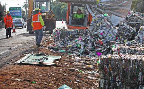 The scene Ulmarra residents woke to after a truck rolled on a Pacific Highway bend at the southern end of the village. The scattered debris was the truck’s cargo of recycled plastic.