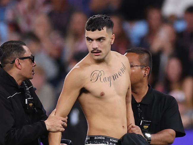 SYDNEY, AUSTRALIA - APRIL 25:  A pitch invader is taken off the field by security during the round eight NRL match between Sydney Roosters and St George Illawarra Dragons at Allianz Stadium on April 25, 2023 in Sydney, Australia. (Photo by Mark Kolbe/Getty Images)