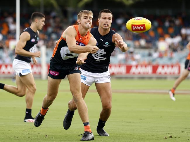 Giants James Leake handballs ahead of Carlton's Jack Silvagni during pre season clash in Canberra. Photo by Phil Hillyard