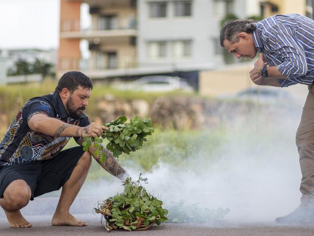 Larrakeyah traditional owner conducting a smoking ceremony outside of the empty lot which is soon to be the Darwin Data Centre location, with Chief Minister Michael Gunner embracing the smoking ceremony. Picture: Floss Adams.