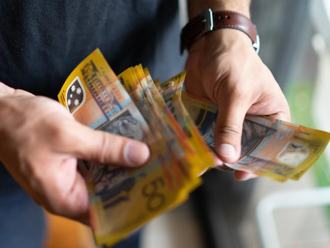 young male counting his savings