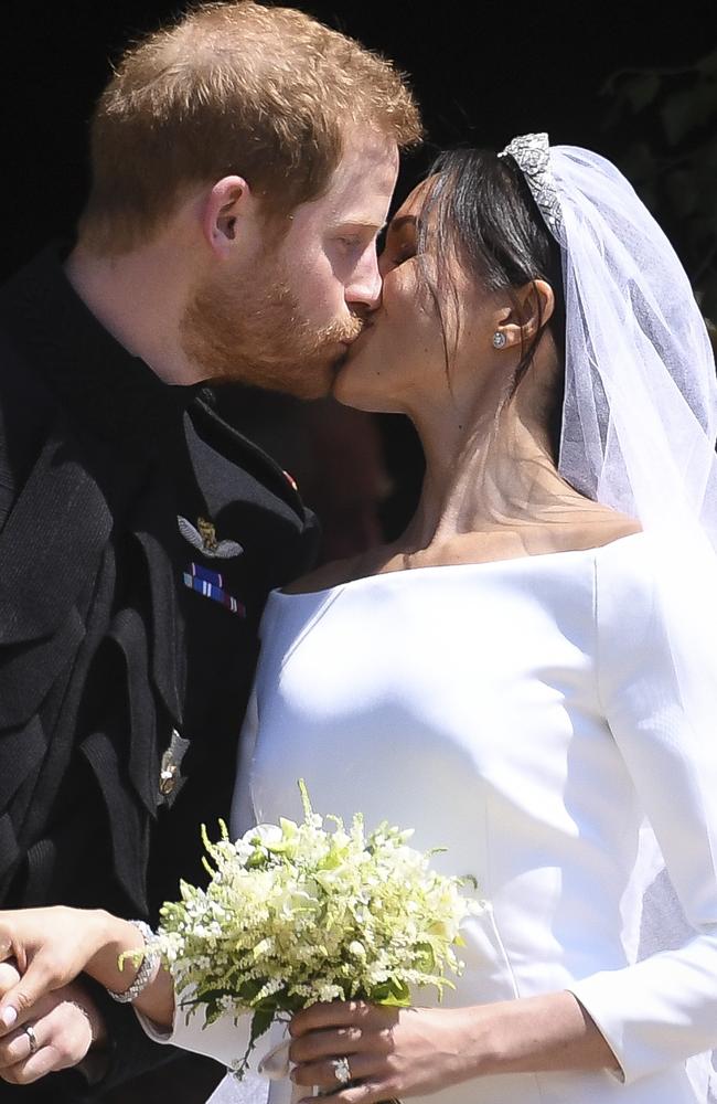 The happy couple share their first kiss as husband and wife.