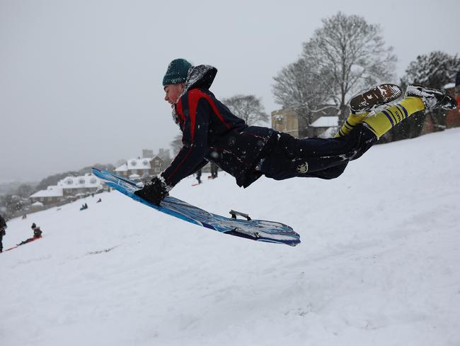 A young man takes a running jump down a snow covered hill with his sledge on February 27, 2018 in Rochester, United Kingdom. Freezing weather conditions dubbed the ‘Beast from the East’ brings snow and sub-zero temperatures to the UK. Picture: Getty Images