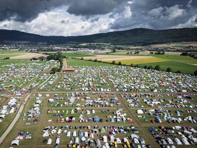 Glastonbury? No, this is the 24th world meeting of Citroen 2CV friends in Switzerland to celebrate the classic French car. Around 5000 Citroen 2CVs from across the globe tootled into the Swiss countryside, taking over an area equivalent to 75 football fields, with a festival zone and camping ground. Picture: Gabriel Monnet/AFP