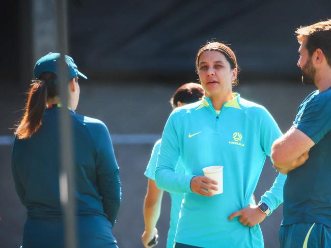 Injured Matildas captain Sam Kerr (centre) talks with team staff before Wednesday’s training session. Picture: Patrick HAMILTON / AFP