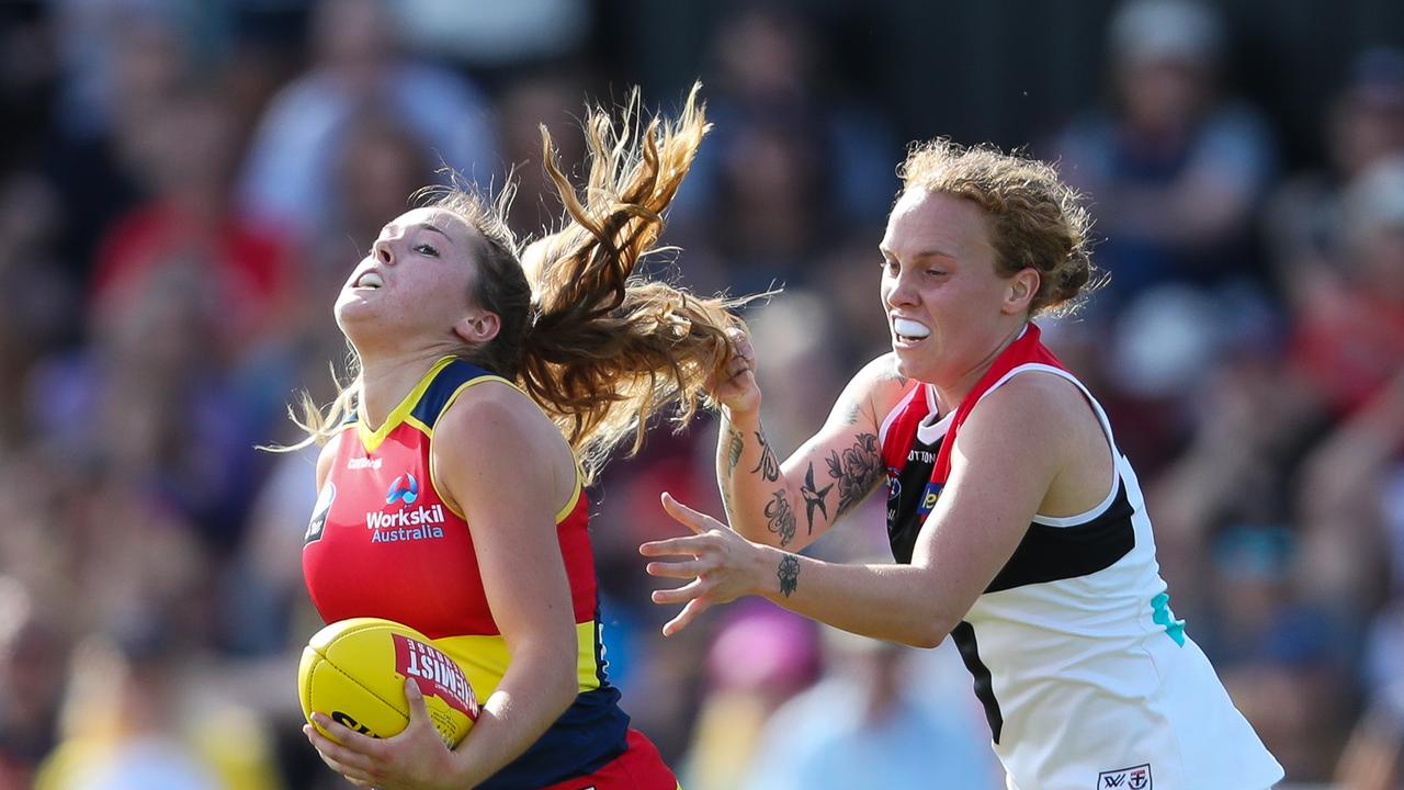 Madison Newman is tackled by Tilly Lucas-Rodd on Sunday.