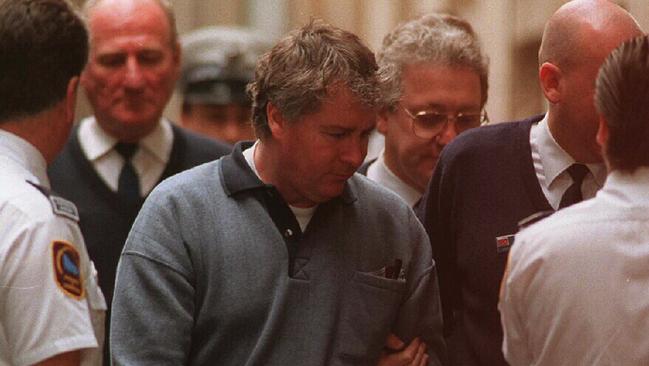 Ashley Mervyn Coulston is led handcuffed into the Supreme Court. Picture: Peter Ward.