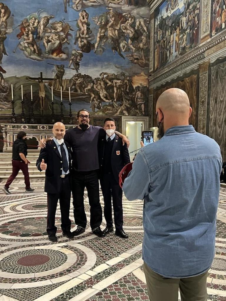 Jason Momoa takes photos inside the Sistine Chapel.