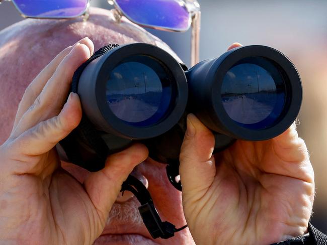 A man uses binoculars to watch the border with Lebanon during a tour in the northern Israeli border town of Metula, on January 7, 2025, after a ceasefire took effect on November 27 after, two months of full-blown war between Israel and Hezbollah. (Photo by Jalaa MAREY / AFP)