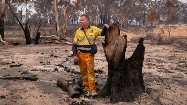 James Fitzgerald inspects his bushfire-scorched koala reserve on February 4, 2020 in Peak View. Picture: John Moore/Getty Images