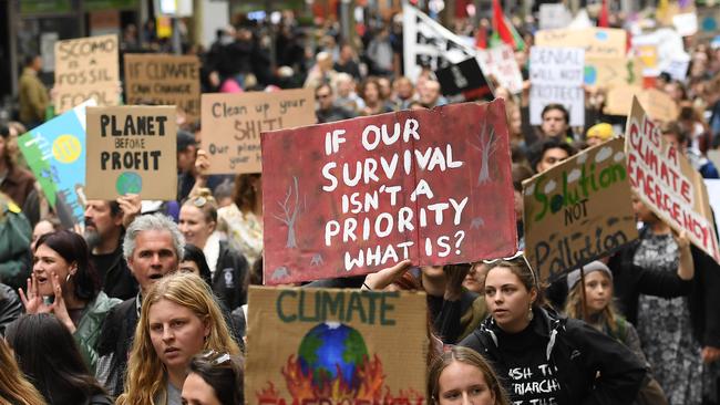 MELBOURNE, AUSTRALIA - MAY 24: Protestors march down city streets on their way to stage a 'Die In' in at the corner of Bourke and Swanston Streets on May 24, 2019 in Melbourne, Australia. Protestors including the 'Extinction Rebellion' took to the CBD in order to show the Earth's sixth mass extinction in reaction to Climate Change. (Photo by Quinn Rooney/Getty Images)