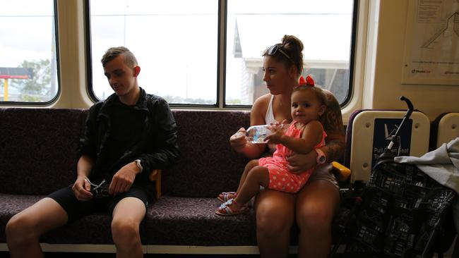 In one of the carriages we come across Lane and his friend Melissa and her little one-year-old Kyiesha, on their way to Darra station.