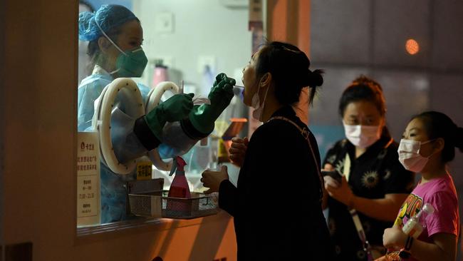 A woman is tested at the Beijing West railway station on Thursday night. Picture: AFP