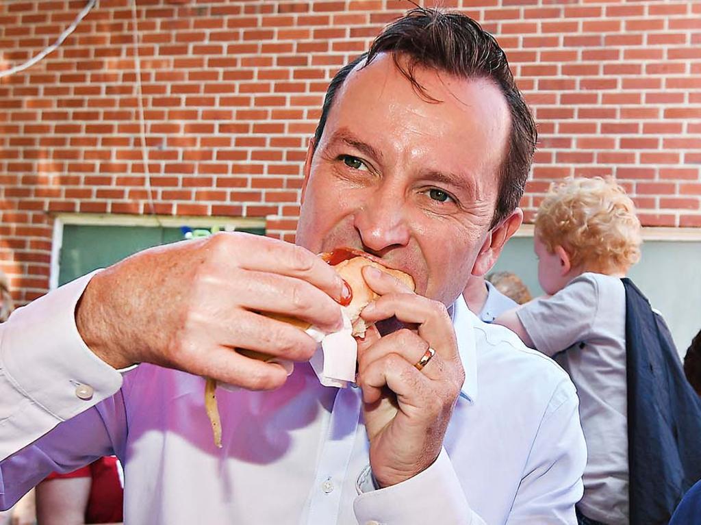 Mr McGowan was happy to dig into a sausage at a polling booth during the state election in 2017 when Labor swept to power. Picture: AAP Image/Dan Peled