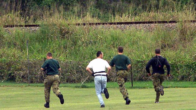 QLD police officers running to capture Robert Paul Long.