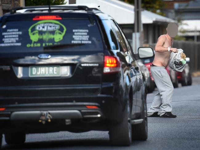 A car brakes to avoid hitting the man. Picture: Tony Gough