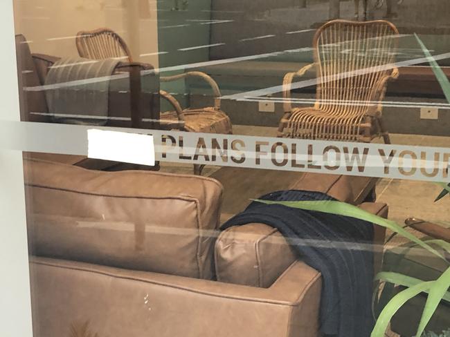 Masking tape placed over an offensive word in a motif on the window of the Stoke Beach House in Raglan St, Manly. Picture: Jim O'Rourke