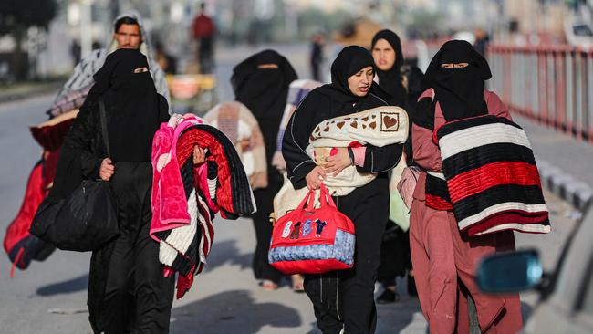 Residents of the refugee camp of Bureij arrive in Deir al-Balah in the central Gaza Strip following an evacuation order, on December 22, 2023, amid the ongoing conflict between Israel and the Palestinian militant group Hamas. (Photo by AFP)