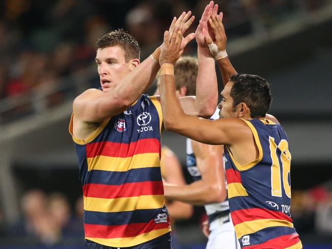 Eddie Betts congratulates team mate Josh Jenkins during the round eight match between the Crows and Geelong. Picture: AAP Image/Ben Macmahon