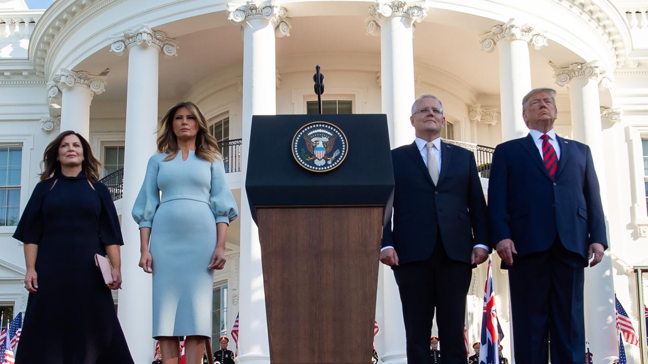 US President Donald Trump, First Lady Melania Trump, Australian Prime Minister Scott Morrison and his wife, Jennifer Morrison, stand for the National Anthems during an arrival ceremony. Picture: SAUL LOEB / AFP