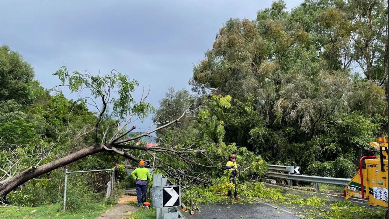 Council staff work to clear a fallen tree from the High Street bridge in North Rockhampton.