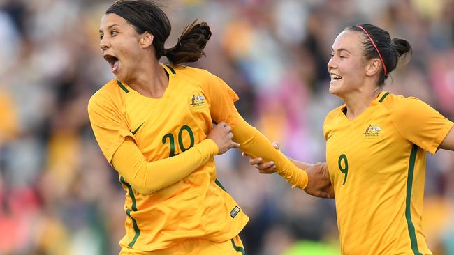 Sam Kerr (left) celebrates her match-winning goal against Brazil.