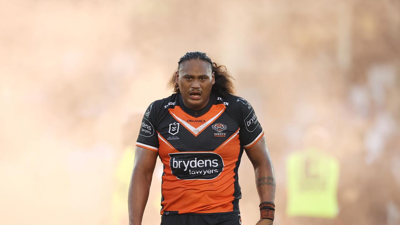 SYDNEY, AUSTRALIA - APRIL 10: Luciano Leilua of the Tigers looks as as smoke from a flare is seen on the field after a pitch invader ran onto the field with a flare during the round five NRL match between the Cronulla Sharks and the Wests Tigers at PointsBet Stadium, on April 10, 2022, in Sydney, Australia. (Photo by Mark Kolbe/Getty Images)