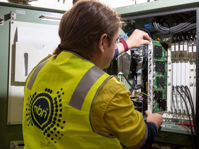 An NBN Co. technician handles hardware in a fiber distribution cabinet during the installation of fiber-to-the-building connections in Sydney, Australia, on Tuesday, Oct. 3, 2017. NBN says it's aiming to increase annual revenue more than five-fold to A$5.4 billion and be cash flow positive in 2021. Photographer: Cole Bennetts/Bloomberg