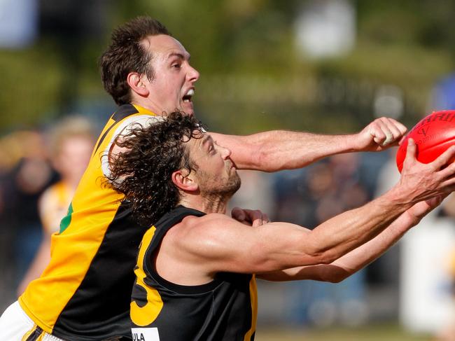 Seaford coach Anthony Agius marks at full stretch despite the efforts of Frankston YCW's Craig Nankervis to spoil in the MPNFL Peninsula division second semi-final. Seaford won.