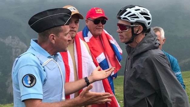 Chris Froome pulled off his bike by police