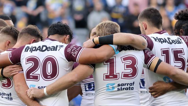 Manly Sea Eagles players take a minute’s silence for Bob Fulton. Picture: Damian Shaw