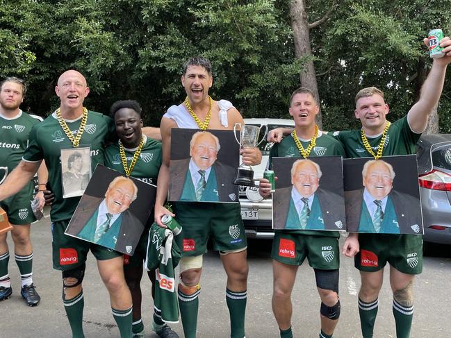 Randwick's fourth grade team celebrate their 2023 premiership win, honouring club legend Jeff Sayle.