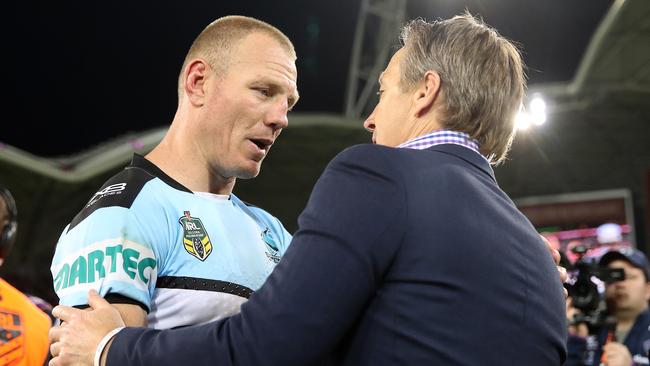 Luke Lewis is congratulated by Storm coach Craig Bellamy on a great career.