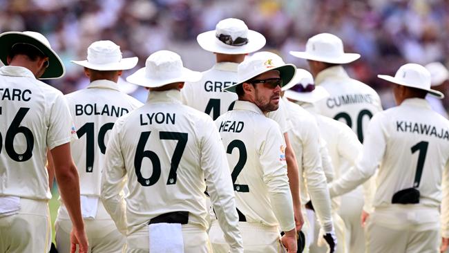 Australia's Travis Head looks around as the Australian players wear floppy hats in memory of Shane Warne.