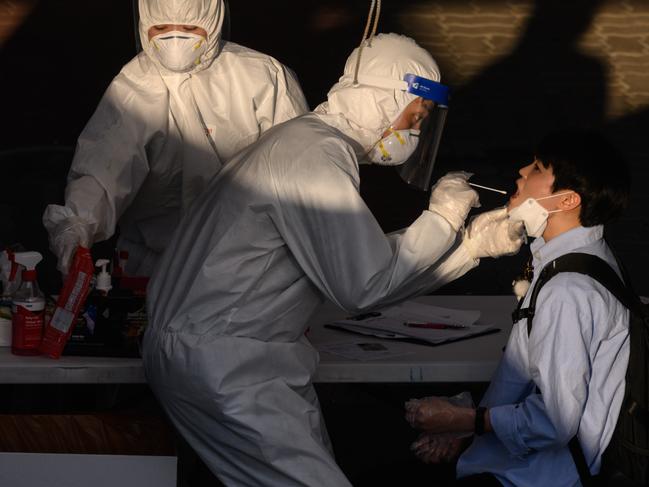 A health worker administers a swab at a temporary COVID-19 testing centre in Bucheon, south of Seoul. Picture: AFP