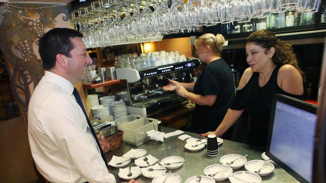 Victorian Leader of the Opposition Matthew Guy speaks with cafe owner Miriam Jamil in Frankston, Melbourne, Monday, November 19, 2018. The opposition leader was speaking about the cost of living ahead of the Victorian State election on Saturday. (AAP Image/David Crosling) NO ARCHIVING