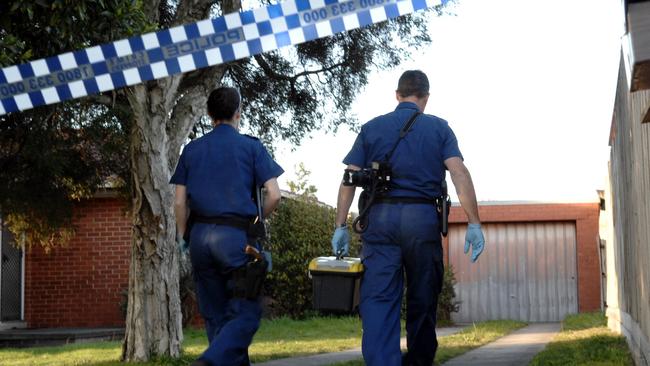 Police at the Mulgrave crime scene where an elderly grandmother was stabbed to death in 2007.