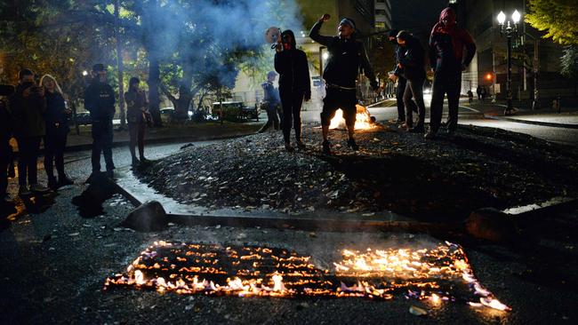 Protesters burn the American flag outside the Mark O. Hatfield United States Courthouse in Portland, Oregon the day after the election. Picture: AFP