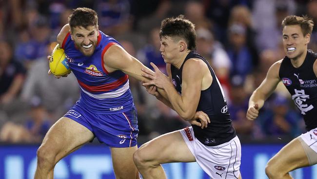 Marcus Bontempelli tries to break the tackle of Sam Walsh. Picture: Michael Klein