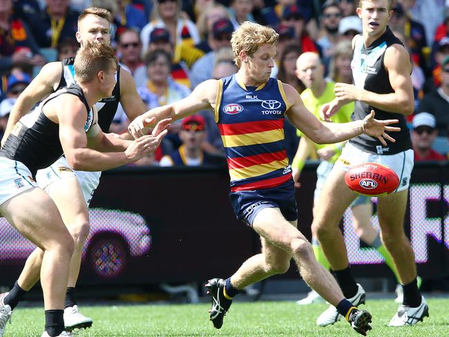 Rory Sloane gets his kick away despite pressure from Ollie Wines. Picture: Sarah Reed.