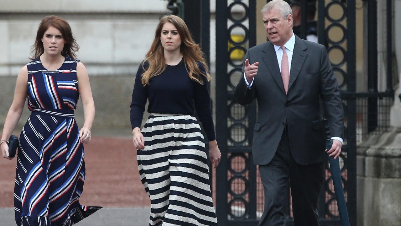 Andrew with his daughters, Princesses Eugenie and Beatrice. Picture: JUSTIN TALLIS / AFP